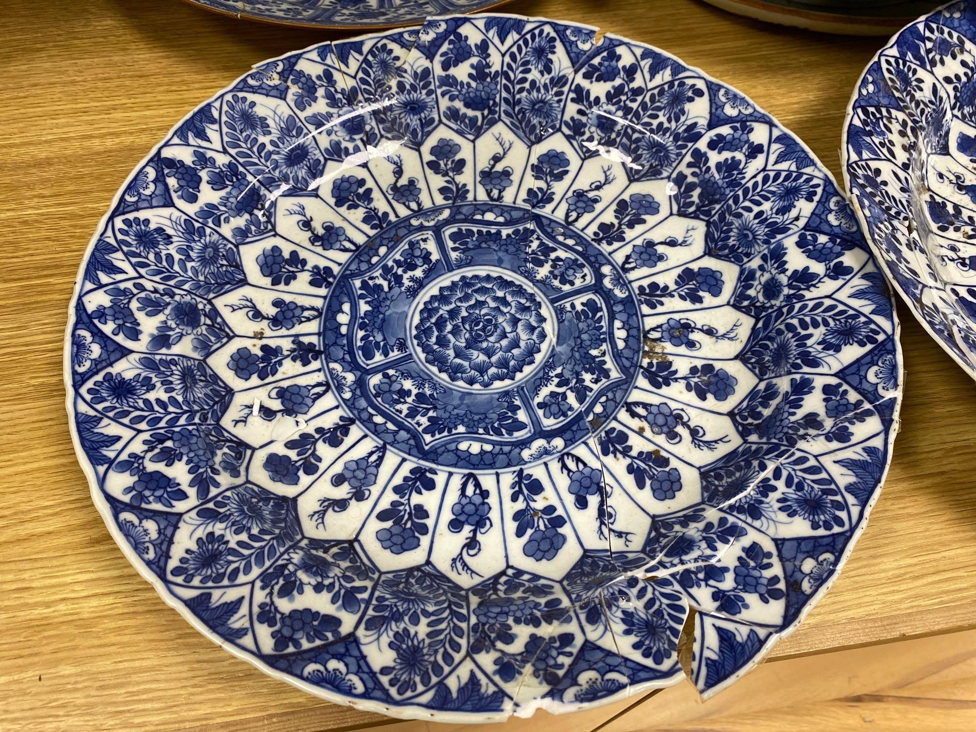 Four Chinese Kangxi period blue and white dishes and a Qianlong blue and white dish